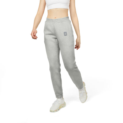 Model wearing Adidas fleece joggers in light gray, paired with a crop top and sneakers, walking with a casual style.